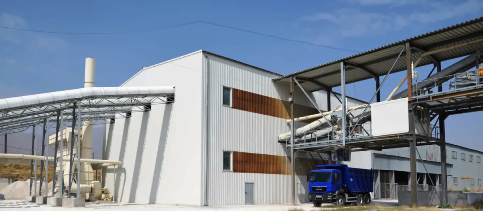A truck being loaded under a covered bay at the Angren Kaolin plant